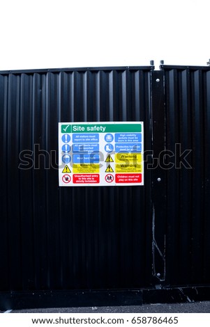 Health and Safety signs on wall outside construction site