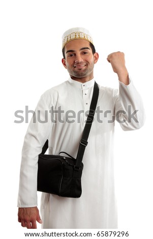 An ethnic arab or south asian man dressed in traditional cultural clothing.  He is smiling and one arm clenched in a victory fist of success Royalty-Free Stock Photo #65879296