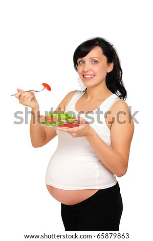 A young pregnant woman chooses a healthy natural food