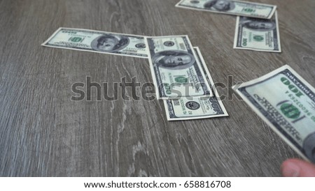 young businessman throws a hundred dollar bill.
