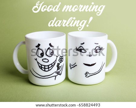 Text GOOD MORNING DARLING and cups with funny faces on color background