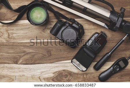 equipment of photography on brown wooden table view from above. short movie production essentials