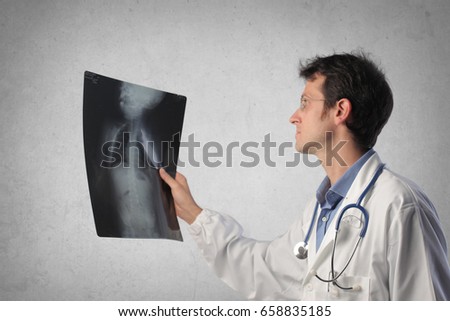 Young doctor examining x-rays
