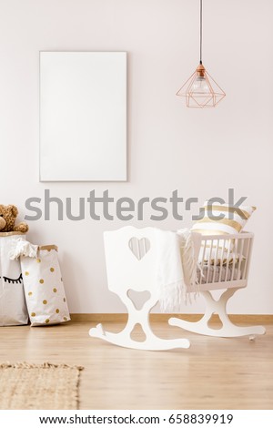 Baby cradle and mockup poster frame in scandinavian interior