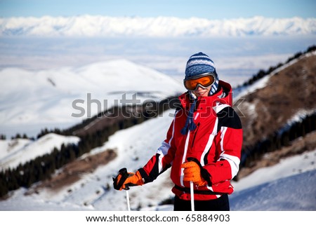 Woman in red on the ski slopes