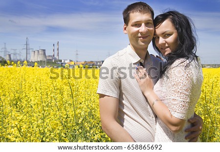 photo of two happiness people on the yellow field and blue sky