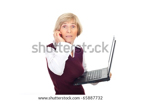 Busy senior businesswoman holding a laptop and receiving surprising news by phone mobile isolated on white background