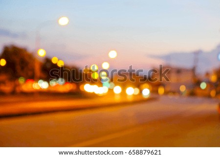 A picture of abstract blurred bokeh traffic light on road in the evening sunset sky.