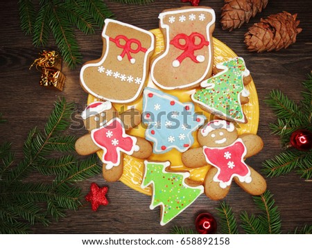 christmas cookies and gingerbread traditional food on wooden board fir branches 
