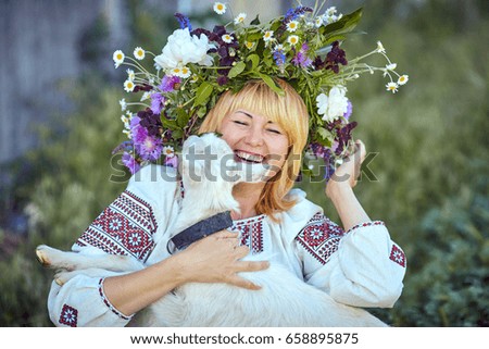 Funny picture a beautiful young girl farmer with a wreath on her