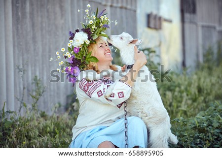 Funny picture a beautiful young girl farmer with a wreath on her