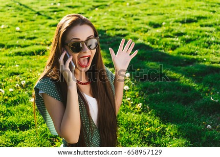 Surprised woman talking on smartphone,wear sunglasses,copyspace