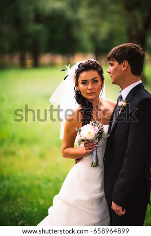 beautiful young couple stand on  background forest