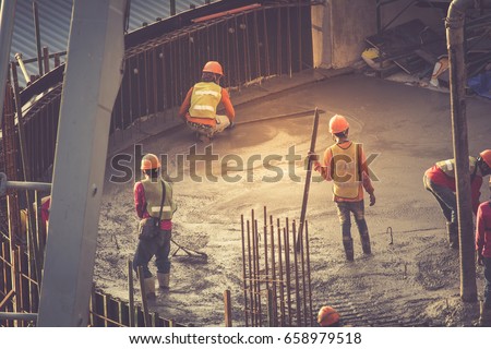 Concrete pouring during commercial concreting floors of buildings in construction Royalty-Free Stock Photo #658979518