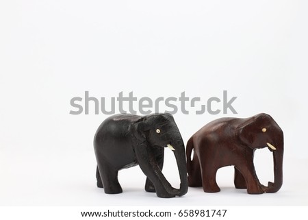 hand carved wooden elephants standing isolated on white background 