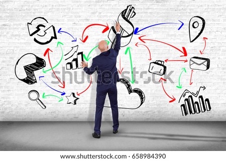 View of a Businessman in front of a wall writing on a business reminder interface application - Technology concept