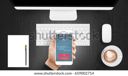 Email app on modern smartphone in man hand with office desk in background. User interface flat design
