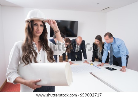 Business people group on meeting with construction engineer architect looking building blueprint in modern office