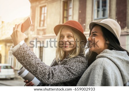 Two young girl. Female best friends taking self-picture with the phone
