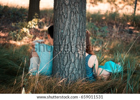 Friends guy and girl near a tree in the nature