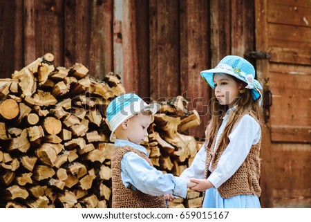 children in hats holding hands and looking at each other