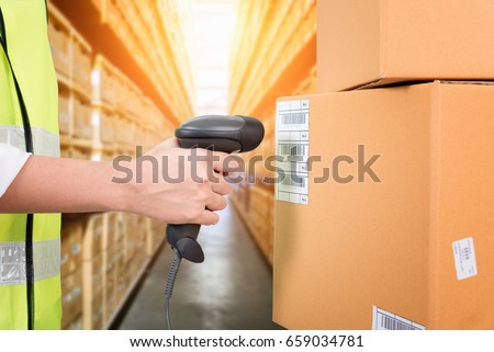 Woman scanning barcode from a label in modern warehouse Royalty-Free Stock Photo #659034781