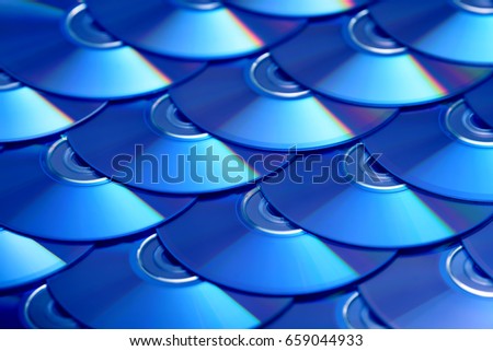 Compact discs background. Several cd dvd blu-ray discs. Optical recordable or rewritable digital data storage.
