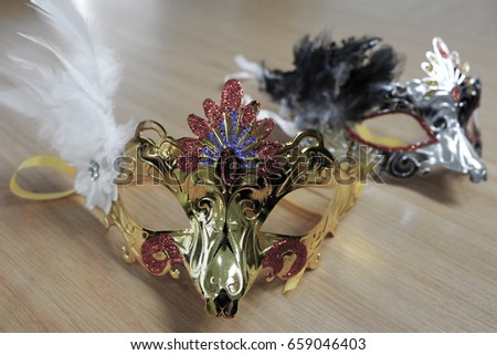 The gold and silver masks on table.