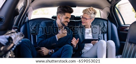 Business people smiling in limousine