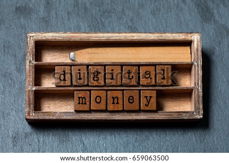 Digital money concept. Vintage box, wooden cubes phrase with old style letters, old pencil. Gray stone textured background. Close-up, up view, soft focus