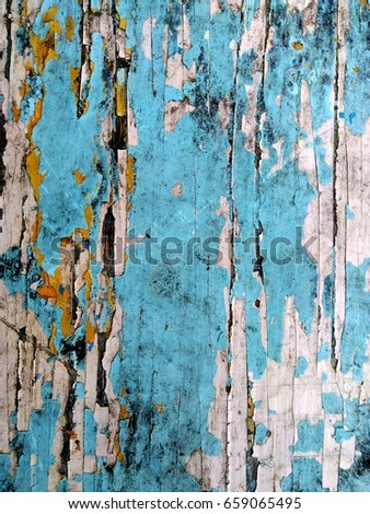 Dirty wall with peeling paint of different colors, grunge background.