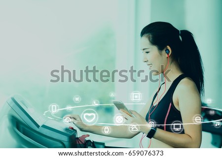 A asian woman using smartphone and smartwatch when her workout with IOT, internet of things sign and icon surround her. Digital era or omni channel concept. Internet on everyday.