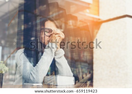 Girl reading  the Bible and praying in the library cafe,in the city,prayer concept for faith,spirituality and religion Royalty-Free Stock Photo #659119423