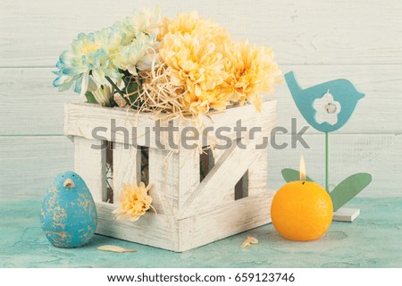 Blue and yellow chrysanthemum in white wooden box on blue concrete background
