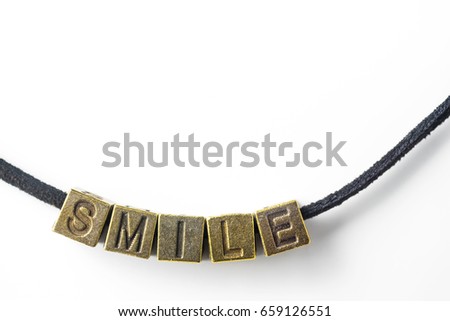 Creative design concept - top view of metal cube word " smile " link with line, isolated on white background