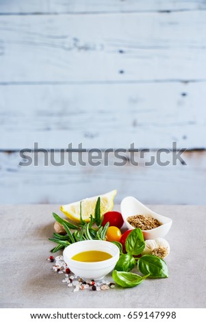 Delicious cooking ingredients, herbs and spices. White wooden wall background, selective focus, copy space. Clean eating, vegan, detox, dieting, gardening or vegetarian food concept.