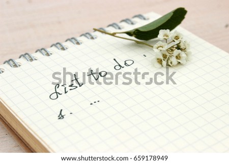 Paper notebook with handwritten text: List to do. Concept for romantic and love theme. Lifestyle and motivation