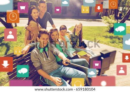 technology, education and people concept - group of happy teenage students or friends taking selfie by smartphone and monopod with menu icon