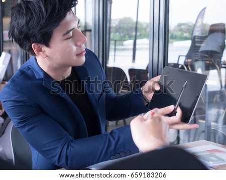 creative young in a business suit with a tie and show display a tablet.