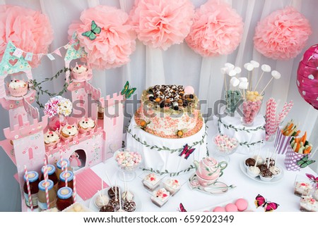 colorful birthday party table with cake
