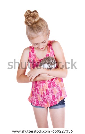 A young girl holding a hedgehog on an isolated white background