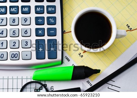 coffee and calculator on paper table with diagram