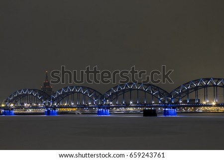 Arched railway bridge in Riga on a winter night. Latvia
