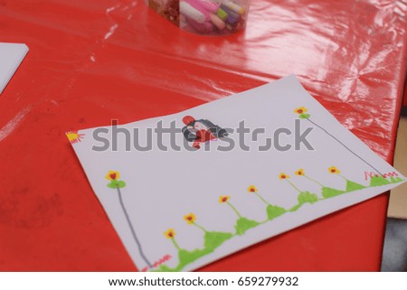 child's colourful picture of flowers and trees 