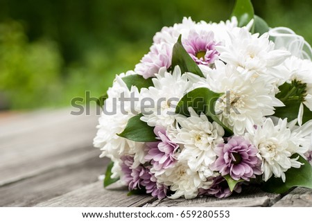 wedding bouquet of asters on the background of old wooden boards