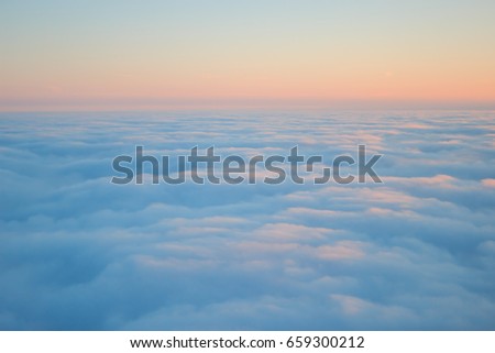 Clouds seen from above on sunrise texture Royalty-Free Stock Photo #659300212
