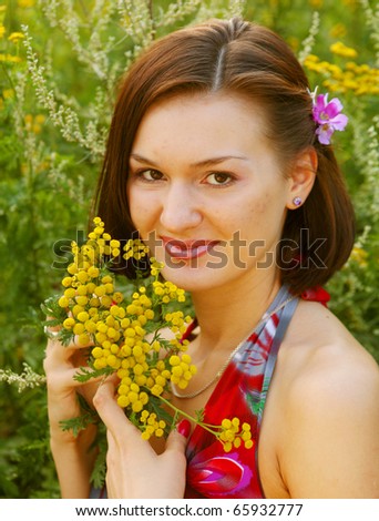 pretty young woman outdoor in the grass in summertime