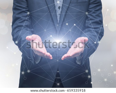 Businessman hand holding the Futuristic network connection technology on gray background, business technology and Social Network concept