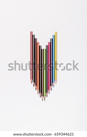 colorful pencils make a arrow on the white background.