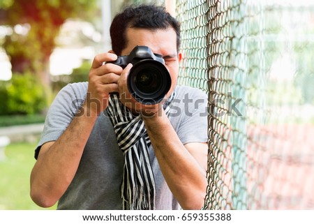 Professional photographer taking picture in city